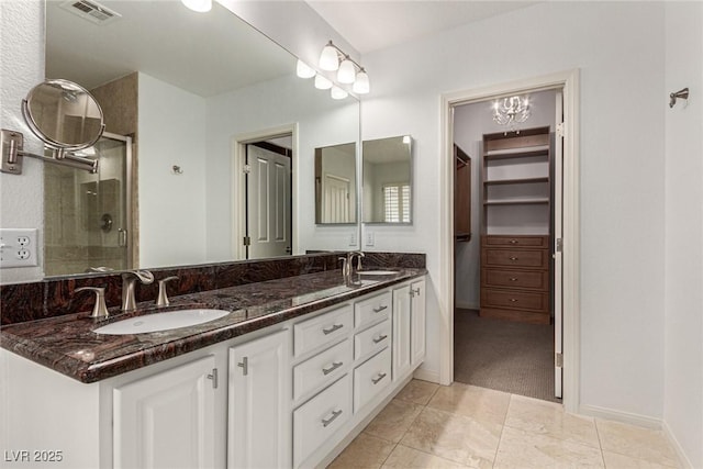 bathroom featuring vanity, tile patterned floors, and walk in shower