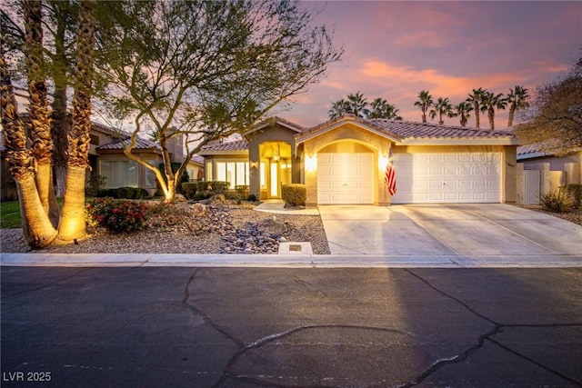 mediterranean / spanish-style home with a garage