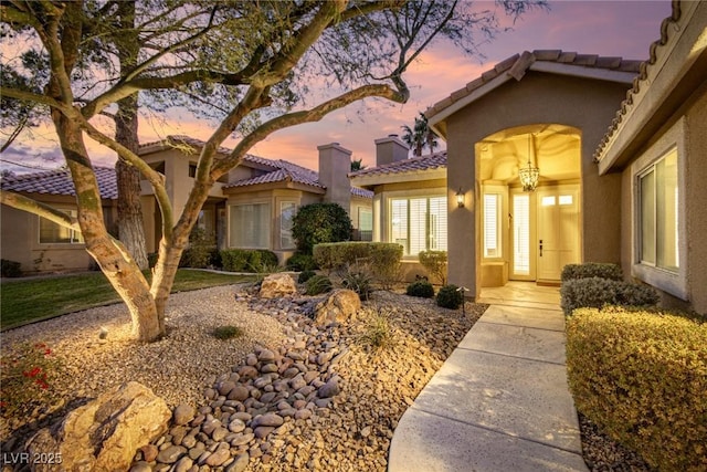 view of exterior entry at dusk