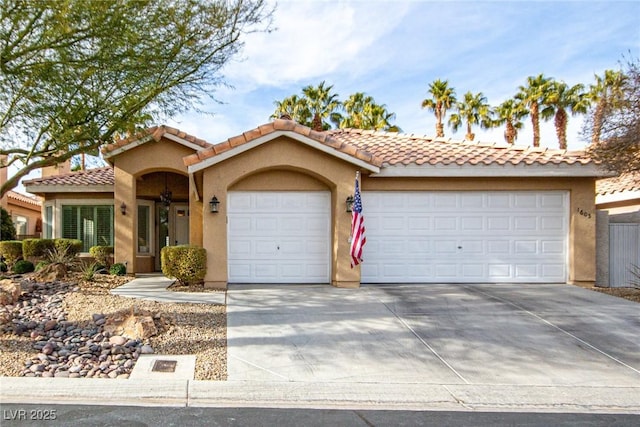 mediterranean / spanish-style home with a garage