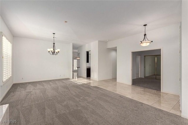 empty room with light carpet and an inviting chandelier