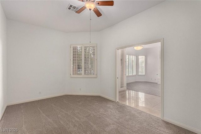 empty room with ceiling fan and light colored carpet