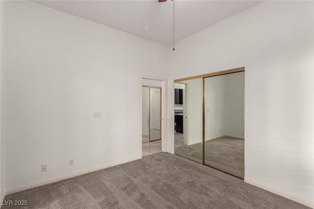 unfurnished bedroom with light carpet, a closet, and ceiling fan