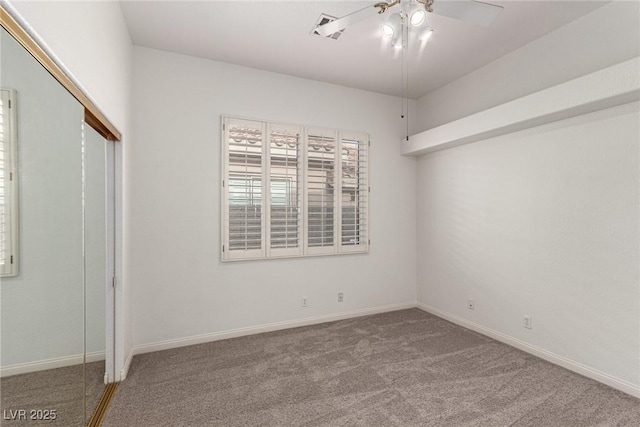 carpeted spare room with ceiling fan