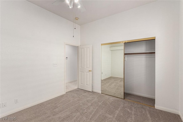 unfurnished bedroom with ceiling fan, carpet floors, and a closet