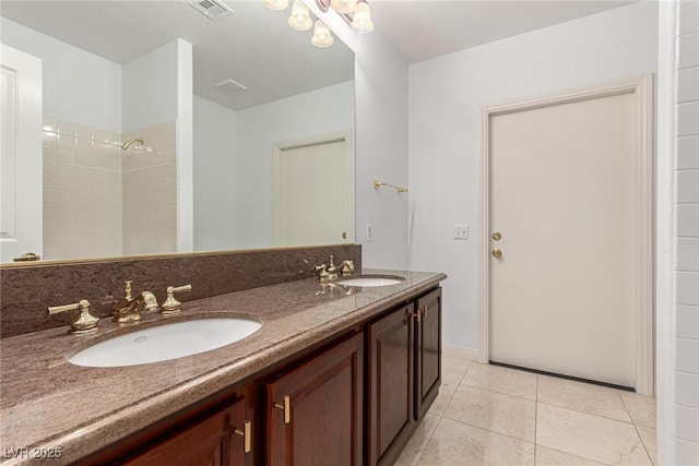 bathroom featuring vanity, a shower, and tile patterned floors