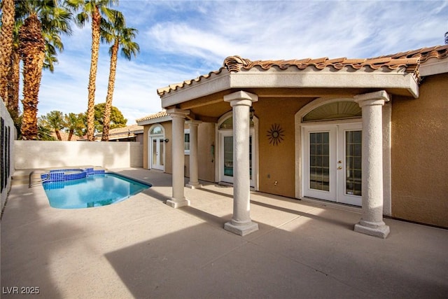 view of swimming pool featuring a patio, french doors, and an in ground hot tub