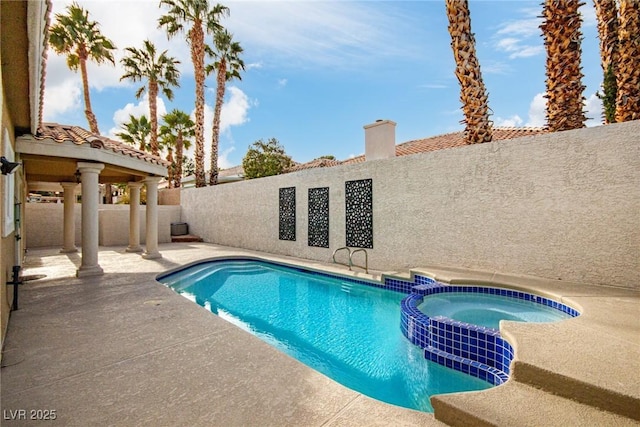 view of swimming pool with an in ground hot tub and a patio