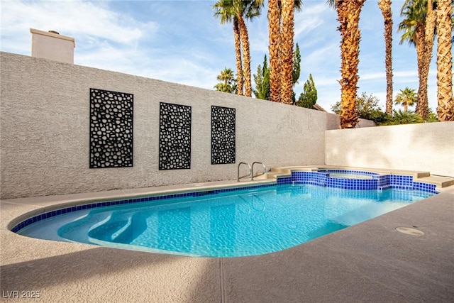 view of pool with an in ground hot tub