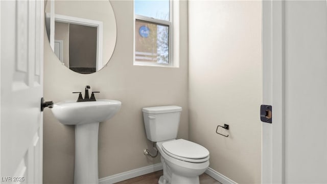 bathroom featuring sink, wood-type flooring, and toilet