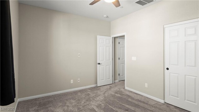 unfurnished bedroom featuring ceiling fan and light carpet