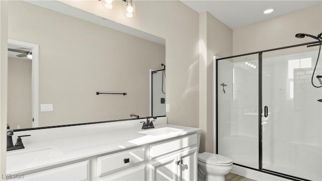 bathroom featuring vanity, toilet, and walk in shower
