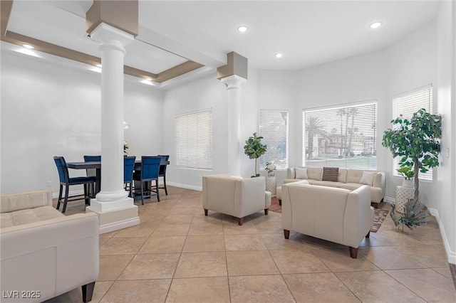 living room featuring decorative columns and light tile patterned floors