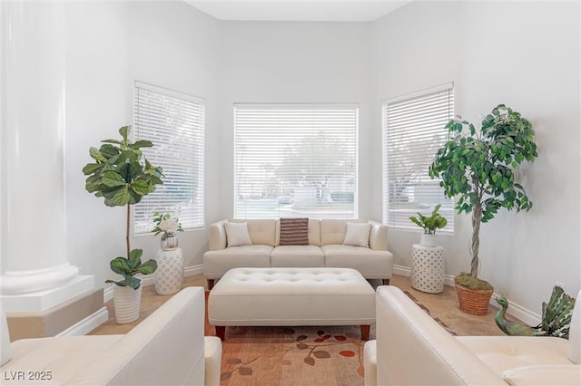 living room featuring ornate columns