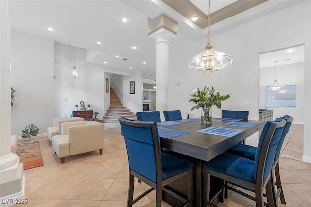 tiled dining area with an inviting chandelier and decorative columns