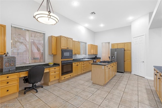 kitchen with a towering ceiling, hanging light fixtures, a center island, light tile patterned floors, and black appliances