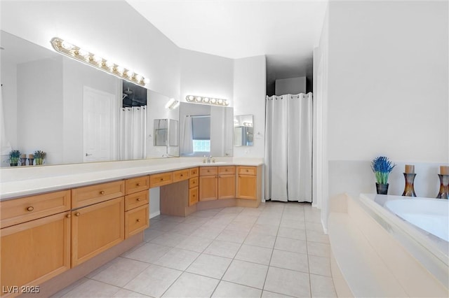 bathroom with tile patterned flooring, vanity, and a tub