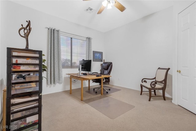 carpeted office space featuring ceiling fan