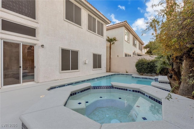 view of pool with an in ground hot tub