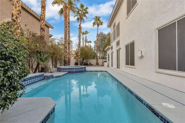 view of swimming pool with an in ground hot tub