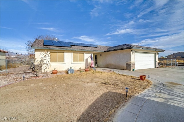 single story home with a garage and solar panels