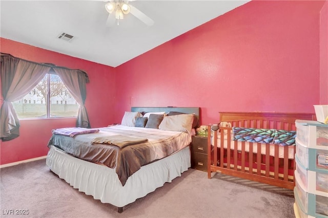 carpeted bedroom with ceiling fan and lofted ceiling