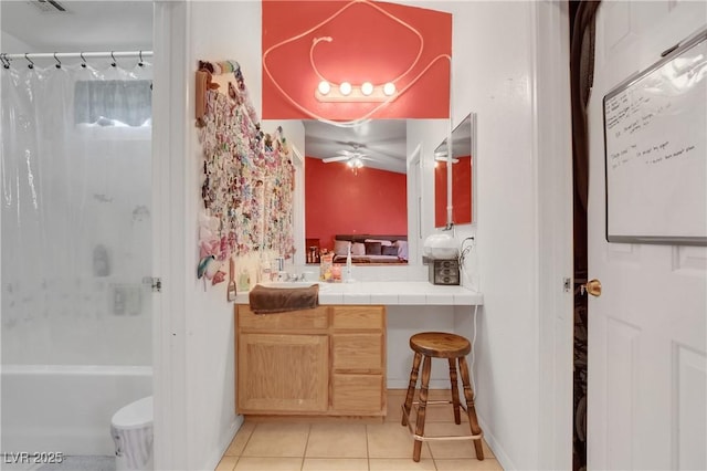 bathroom featuring tile patterned flooring, vanity, and shower / bath combination with curtain