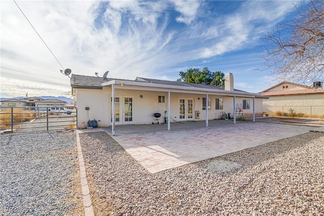 rear view of house featuring a patio and french doors