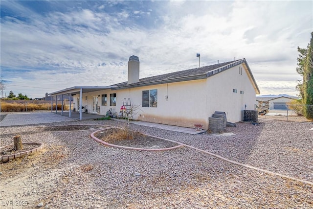 rear view of house featuring cooling unit and a patio