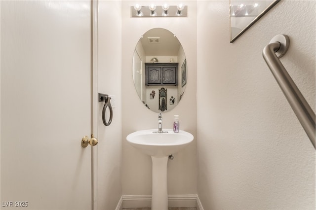 bathroom with baseboards and visible vents