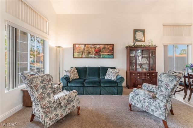 carpeted living area with baseboards