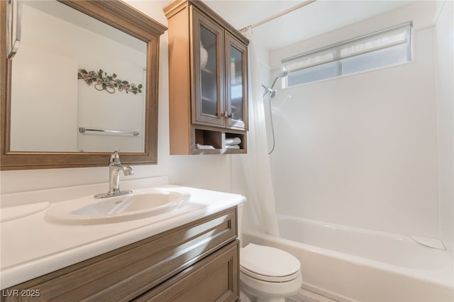 bathroom featuring toilet, shower / washtub combination, and vanity
