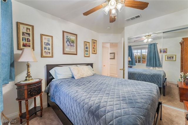 bedroom with visible vents, a closet, ceiling fan, and carpet flooring