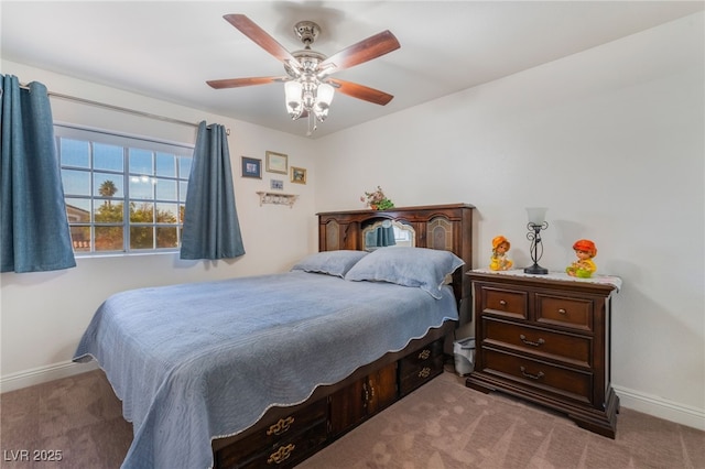 bedroom with ceiling fan, baseboards, and carpet floors