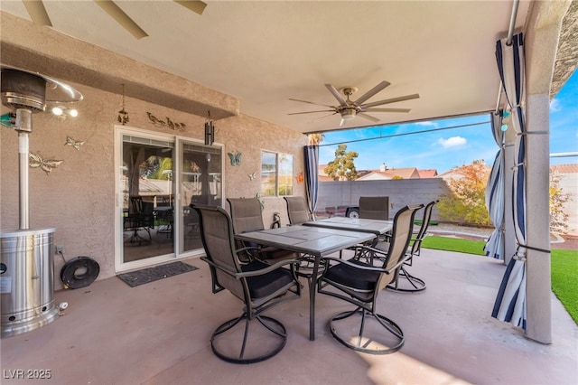 view of patio / terrace with outdoor dining space, a ceiling fan, and fence