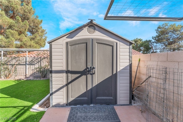 view of shed with a fenced backyard