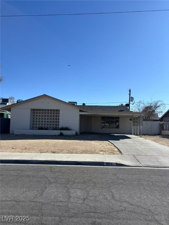 view of front of property with driveway and fence