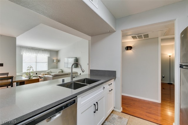 2300 E Silverado Ranch Blvd Unit 2162, Las Vegas, NV 89183 - kitchen featuring white cabinetry, sink, stainless steel dishwasher, and light wood-type flooring