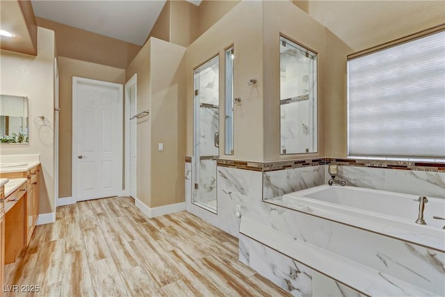 bathroom with shower with separate bathtub, wood-type flooring, and vanity