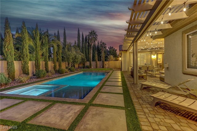 pool at dusk with an in ground hot tub, an outdoor hangout area, a patio, and a pergola