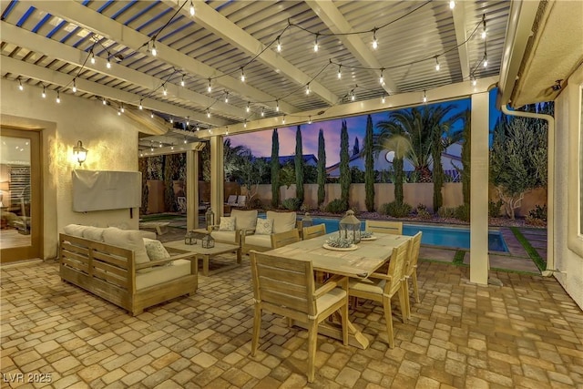 patio terrace at dusk with a fenced in pool, a pergola, and an outdoor living space