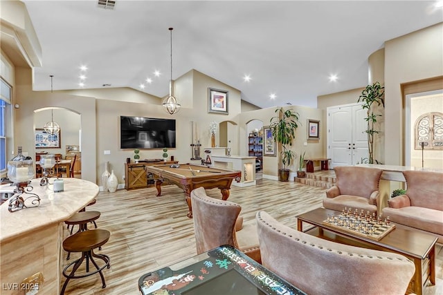 living room with lofted ceiling, pool table, and light hardwood / wood-style floors