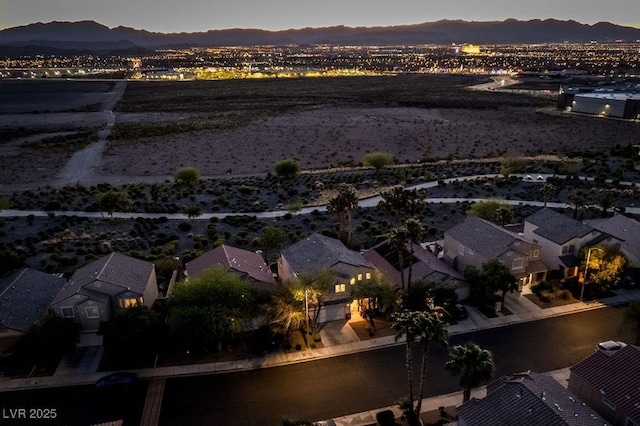 aerial view at dusk featuring a mountain view