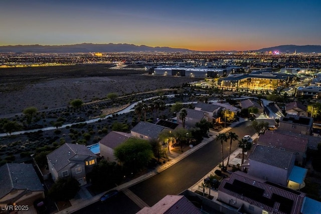 aerial view at dusk featuring a mountain view