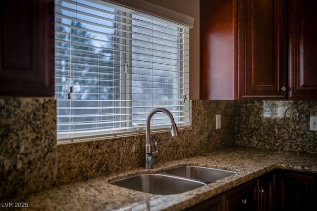 kitchen with sink, backsplash, and stone countertops