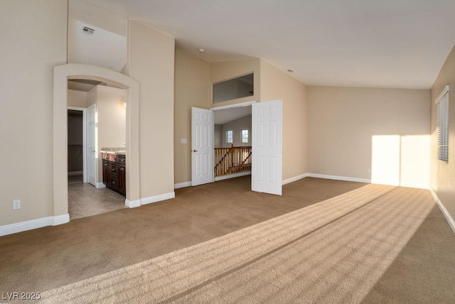 interior space with vaulted ceiling and carpet flooring