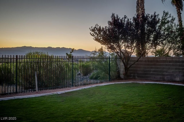 yard at dusk featuring a mountain view