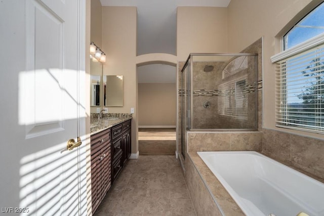 bathroom featuring tile patterned floors, vanity, shower with separate bathtub, and plenty of natural light