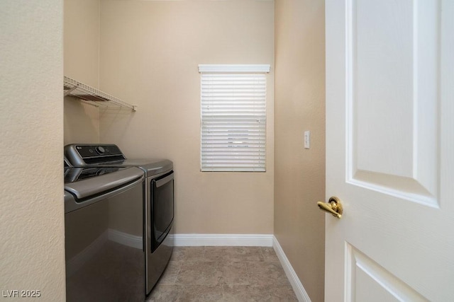 washroom with light tile patterned floors and washer and clothes dryer