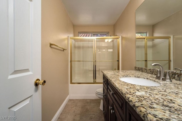 full bathroom with vanity, combined bath / shower with glass door, and toilet